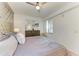 Bright main bedroom with a ceiling fan, dresser, and window letting in natural light at 18114 Gawthrop Dr # 306, Bradenton, FL 34211