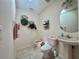 Cozy bathroom featuring a toilet, bidet, sink, and decorative wall art at 18513 Placid Ave, Port Charlotte, FL 33948