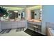 Bright bathroom featuring double vanities with Hollywood lighting, and a glass-enclosed shower at 18513 Placid Ave, Port Charlotte, FL 33948