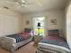 Shared bedroom with two twin beds, a ceiling fan, and window views at 18513 Placid Ave, Port Charlotte, FL 33948