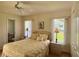 Bright bedroom with large windows, ceiling fan and ensuite bathroom access at 18513 Placid Ave, Port Charlotte, FL 33948
