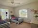 Bedroom featuring two beds, a ceiling fan, and bright natural light at 18513 Placid Ave, Port Charlotte, FL 33948