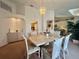 Inviting dining area featuring a chandelier, arched entryways, and direct access to other living spaces at 18513 Placid Ave, Port Charlotte, FL 33948