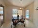 Bright dining area featuring a glass table, seating for four, and a view of the pool at 18513 Placid Ave, Port Charlotte, FL 33948
