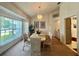 Formal dining room with a large window, chandelier, and comfortable seating for elegant gatherings at 18513 Placid Ave, Port Charlotte, FL 33948