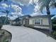 Well-maintained single Gathering home with mature landscaping, palm trees and a circular driveway at 18513 Placid Ave, Port Charlotte, FL 33948