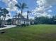 Well-maintained single Gathering home with a large manicured front yard with palm trees at 18513 Placid Ave, Port Charlotte, FL 33948