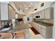Spacious kitchen with light-colored cabinets, stainless steel appliances, and an island with bar seating at 18513 Placid Ave, Port Charlotte, FL 33948