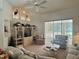 Bright living room with a view of the pool and outdoor area through large sliding glass doors and vertical blinds at 18513 Placid Ave, Port Charlotte, FL 33948