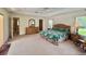 Spacious main bedroom featuring a tropical themed comforter, and an ensuite bathroom at 18513 Placid Ave, Port Charlotte, FL 33948