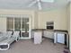 An outdoor kitchen area featuring a countertop, sink, mini-fridge and access to the pool at 18513 Placid Ave, Port Charlotte, FL 33948