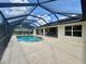 A beautiful screened-in pool area with a large deck and blue skies at 18513 Placid Ave, Port Charlotte, FL 33948