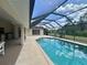 Backyard showcasing a screened-in pool and lanai, perfect for outdoor relaxation and entertainment at 18513 Placid Ave, Port Charlotte, FL 33948