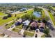 Aerial view of well-kept homes, lush greenery, pond, and the convenience of the nearby highway at 206 Bedford St, Oldsmar, FL 34677