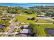 Aerial view showcasing neighborhood homes near lush landscapes, roads, and waterways. Great curb appeal at 206 Bedford St, Oldsmar, FL 34677