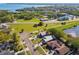 Aerial view showcasing neighborhood homes near lush landscapes, roads, and waterways. Great curb appeal at 206 Bedford St, Oldsmar, FL 34677