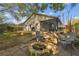 Backyard featuring a fire pit, wooden deck, and mature trees offering privacy and shade at 206 Bedford St, Oldsmar, FL 34677