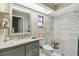Modern bathroom features a marble vanity, floating shelves, and a stunning white tiled walk-in shower at 206 Bedford St, Oldsmar, FL 34677