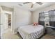 Comfortable bedroom with a ceiling fan, natural light, and a calm atmosphere to promote a restful sleep at 206 Bedford St, Oldsmar, FL 34677
