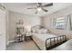 Bright bedroom featuring soft carpet, a ceiling fan, closet, and a large window with natural light at 206 Bedford St, Oldsmar, FL 34677