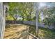 Spacious wooden deck in backyard, ideal for outdoor grilling and entertaining under the trees at 206 Bedford St, Oldsmar, FL 34677