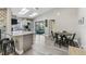 Bright kitchen and dining area with skylights, stainless steel appliances, and outdoor views at 206 Bedford St, Oldsmar, FL 34677