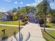 Charming one-story home featuring a well-manicured front yard, driveway, and a basketball hoop at 206 Bedford St, Oldsmar, FL 34677