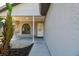 Charming front entrance with a cozy porch swing and neutral-toned exterior, creating an inviting welcome at 206 Bedford St, Oldsmar, FL 34677