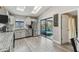 Well-lit kitchen featuring stainless steel appliances, white cabinetry, and an open layout to the patio at 206 Bedford St, Oldsmar, FL 34677