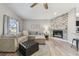 Cozy living room with a brick fireplace, plush seating, and abundant natural light at 206 Bedford St, Oldsmar, FL 34677