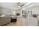 Spacious living room featuring a brick fireplace, vaulted ceilings, and an open layout at 206 Bedford St, Oldsmar, FL 34677