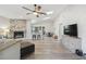 Bright living room with vaulted ceilings, skylights, brick fireplace, and an open floor plan at 206 Bedford St, Oldsmar, FL 34677