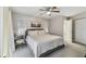 Comfortable main bedroom with neutral tones, a ceiling fan, and ensuite bathroom access for added privacy at 206 Bedford St, Oldsmar, FL 34677