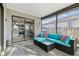 Cozy screened patio with modern furniture and tile flooring, great for relaxing or entertaining guests at 206 Bedford St, Oldsmar, FL 34677