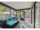 Relax on the screened-in porch, offering cozy seating and views of the lush backyard for outdoor enjoyment at 206 Bedford St, Oldsmar, FL 34677