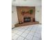 Brick fireplace with a wooden mantle, perfect for cozy nights at 22116 26Th E Ave, Bradenton, FL 34211