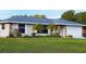 Charming single-story home featuring a well-maintained lawn, beautiful landscaping, and an attached two car garage at 22116 26Th E Ave, Bradenton, FL 34211