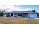 Charming single-story home featuring a well-manicured lawn, a two-car garage, and a quaint detached garage at 22116 26Th E Ave, Bradenton, FL 34211