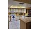 Bright kitchen with tile floors, white cabinets, a skylight, and an island at 22116 26Th E Ave, Bradenton, FL 34211