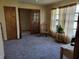 Cozy living room features plush carpeting, a ceiling fan, and large windows that let in plenty of natural light at 22116 26Th E Ave, Bradenton, FL 34211