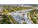 Aerial view of a residential area, highlighting the property's location amidst green spaces and a nearby city skyline at 2344 Lindstrom St, Sarasota, FL 34237