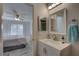 Bright bathroom features a white vanity, square mirror, and view into the primary bedroom at 2825 74Th W St, Bradenton, FL 34209