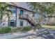 Exterior of the condo building showcasing its well-maintained landscaping and private entry stairway at 2825 74Th W St, Bradenton, FL 34209