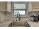 Close-up of kitchen sink with stylish faucet, tile backsplash, and ample counter space at 2825 74Th W St, Bradenton, FL 34209