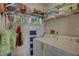 Functional laundry room with stacked washer and dryer, shelving, and cleaning supplies at 2825 74Th W St, Bradenton, FL 34209