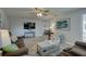 Comfortable living room showcasing a ceiling fan, beach decor, and neutral colors at 2825 74Th W St, Bradenton, FL 34209