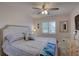 Relaxing bedroom featuring calming colors, ceiling fan, and window with plantation shutters at 2825 74Th W St, Bradenton, FL 34209