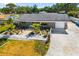 Drone shot of the home with well-maintained landscaping, a private driveway, and a charming exterior at 2929 Siesta Dr, Venice, FL 34293