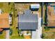 Overhead aerial view of the home showing roof, yard, driveway, and nearby buildings at 2929 Siesta Dr, Venice, FL 34293