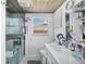 Bright bathroom with a window, a modern vanity, and a glass enclosed shower with seating at 2929 Siesta Dr, Venice, FL 34293
